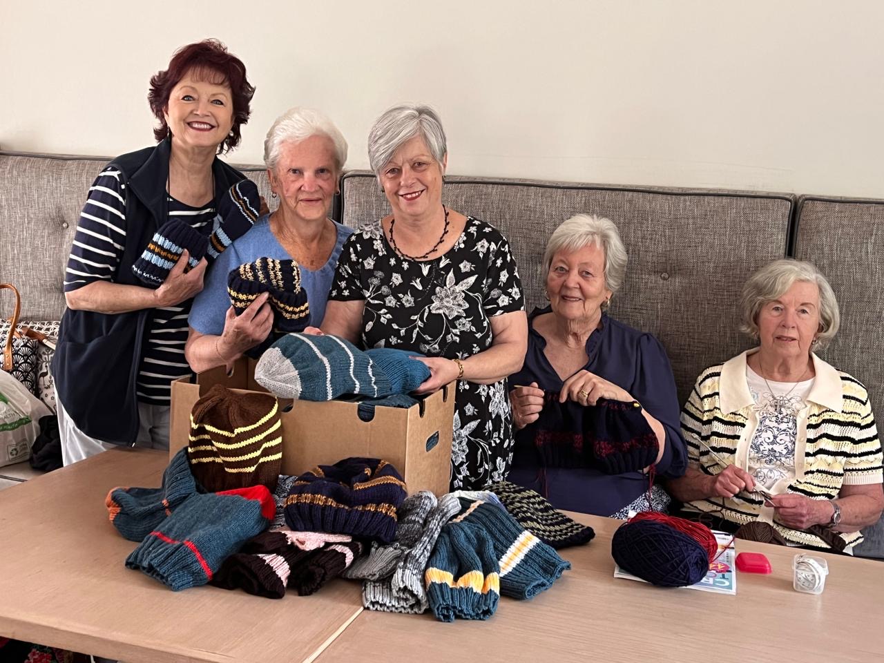 Warm Hearts volunteers with hand-knitted clothing for seafarers