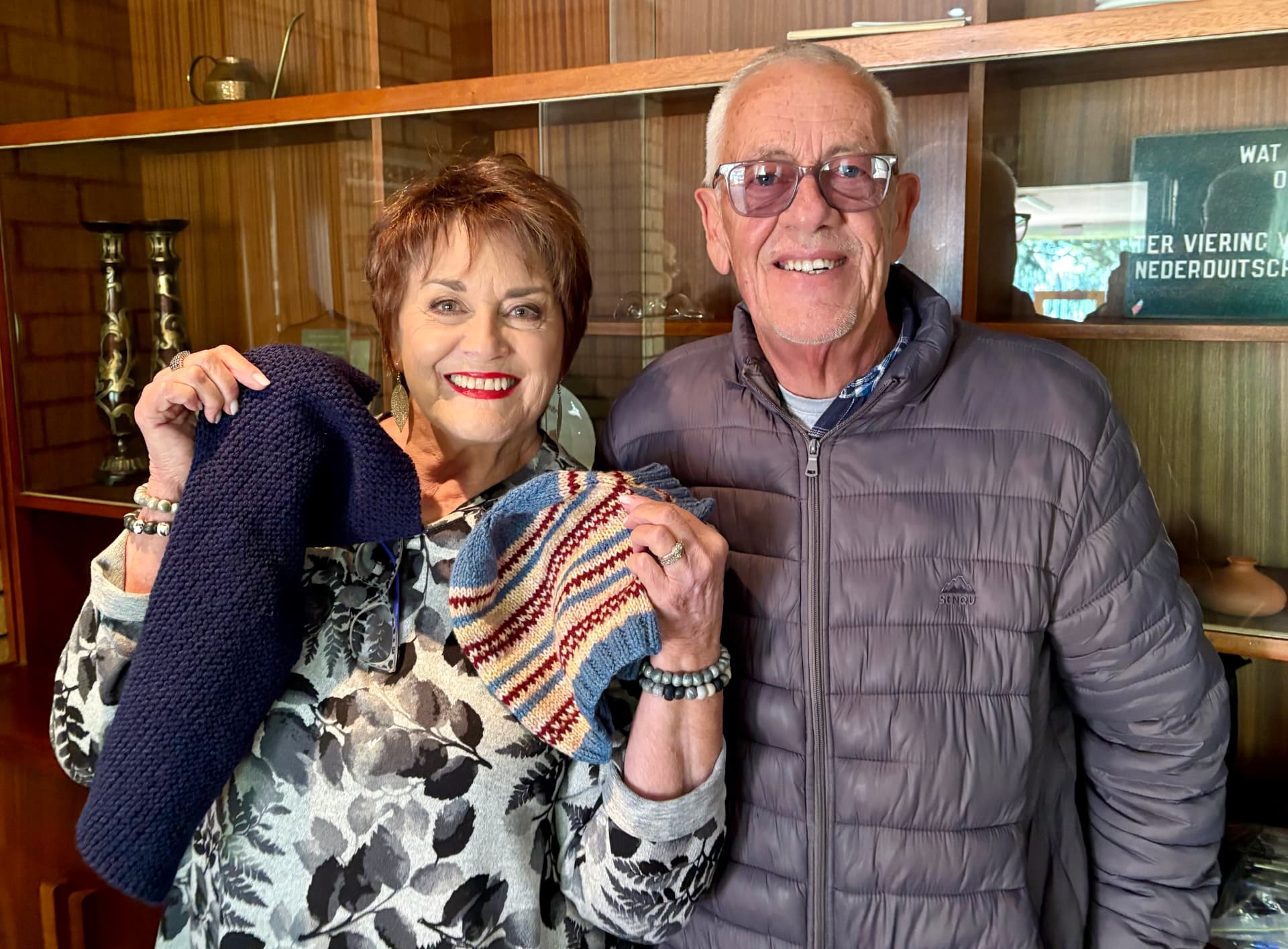 Warm Hearts supporters holding hand-knitted clothing
