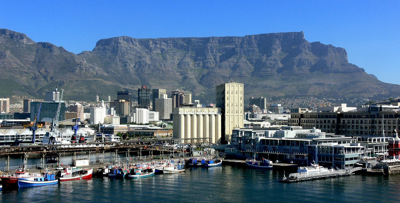 Cape Town harbour with ships alongside the quay and Table Mountain behind